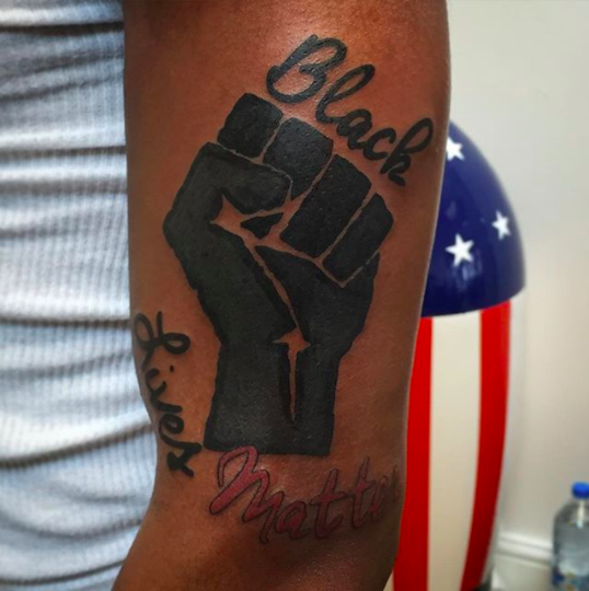 Beautiful and stylized hand and arm of african american person with fist up  and a big tattoo of black live matters over 100 white background Photos   Adobe Stock