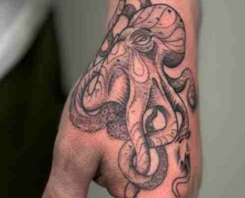 Octopus side hand tattoo